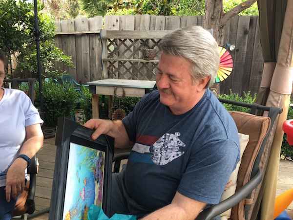 My dad unwrapping his underwater illustration. Photo Credit: J.H. Winter